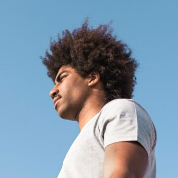 man with afro looking into the distance