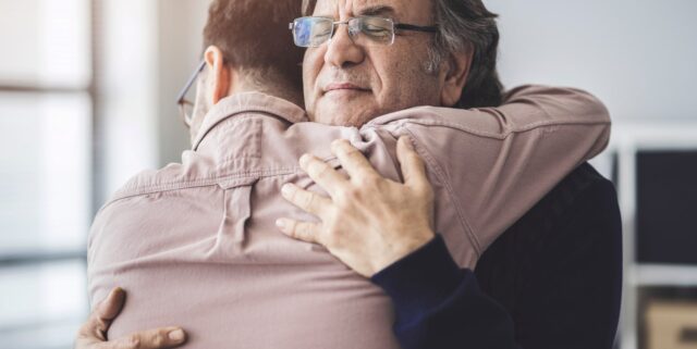 father and son hugging