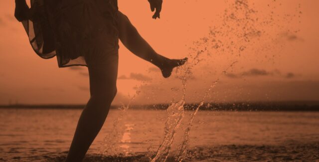 person splashing water with their feet