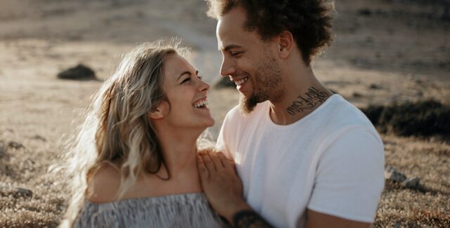 couple smiling whilst looking at each other