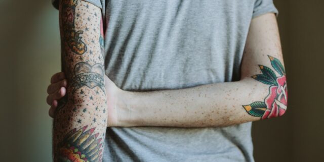 picture of mans tattooed arms
