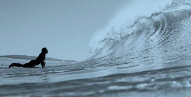 Surfer faceing a wave